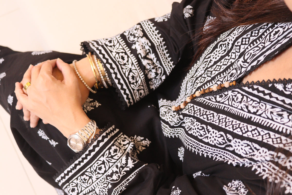 Naqsh white block-printed neckline and cuffs on black lawn, seated close-up