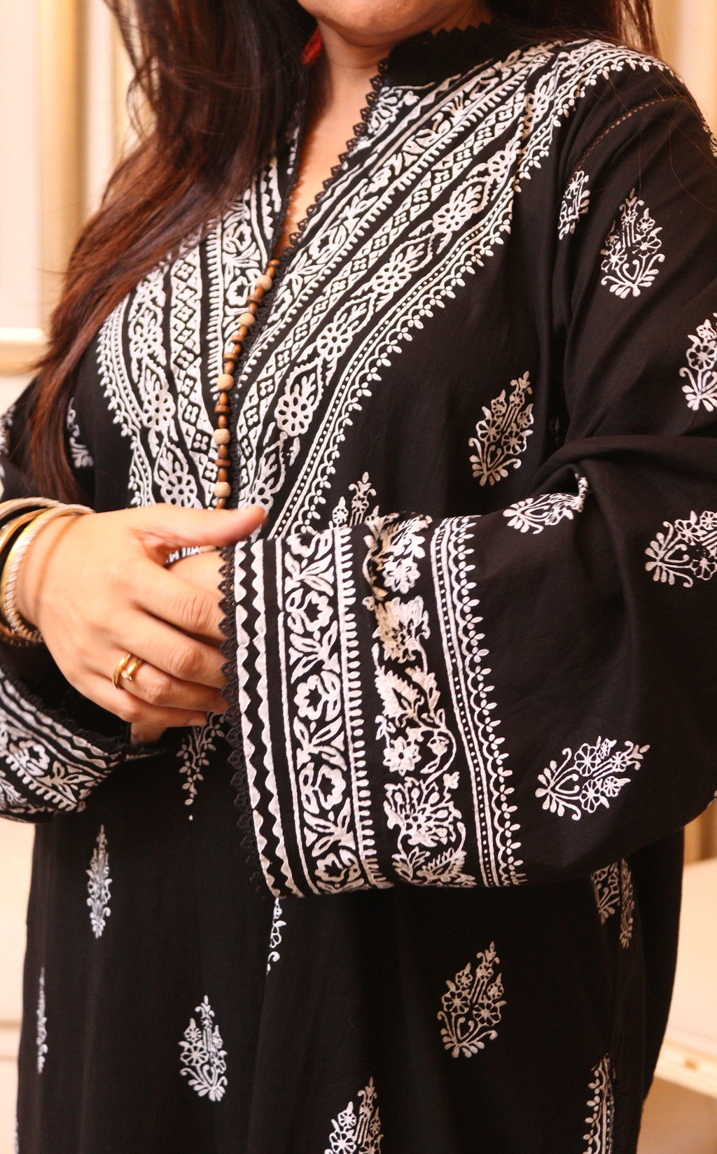 Close-up of Naqsh white block-printed neckline and wide sleeve border